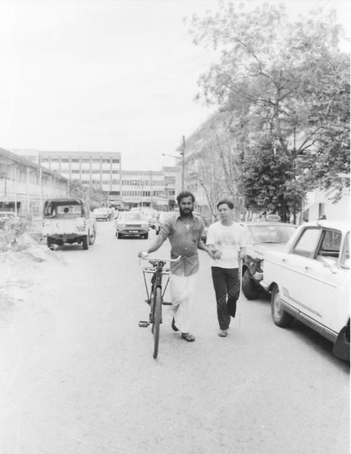 CYCLIST HELPING BLIND MAN