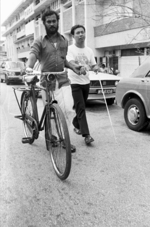 a man riding a bike down a street