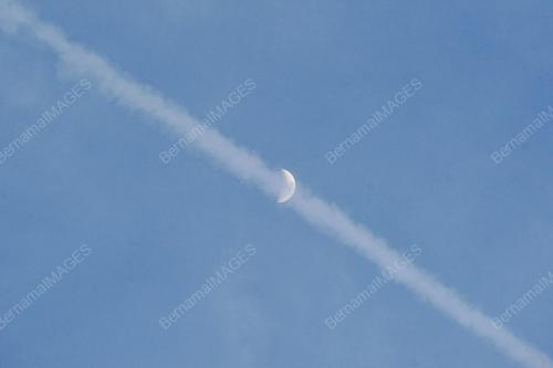THE WAXING CRESCENT MOON AND CONTRAILS