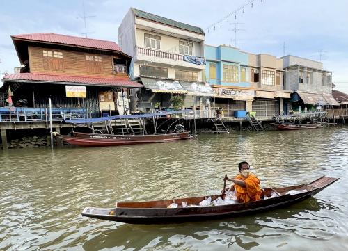 A MONK ROWING A BOAT